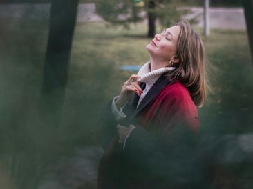 A woman enjoys the sun in nature.